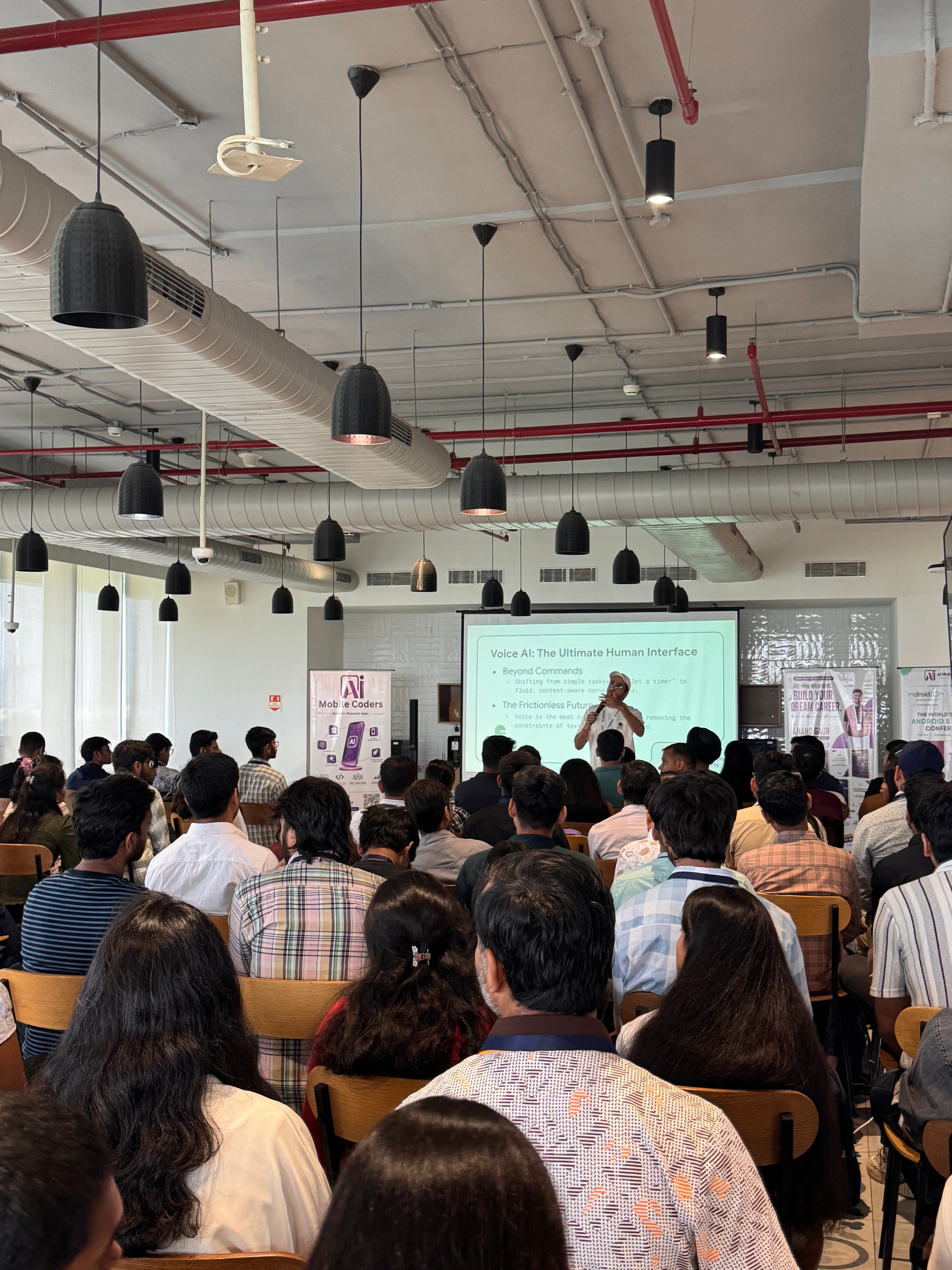 An audience listening to a presentation about Voice AI: The Ultimate Human Interface